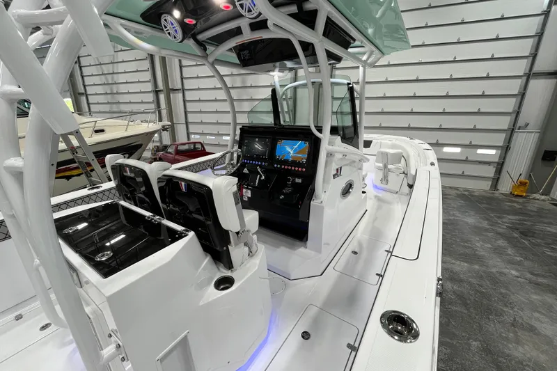 Slide: The Image of 2026 Wellcraft 302 Fisherman boat interior with modern dashboard and seating in a showroom. - 15