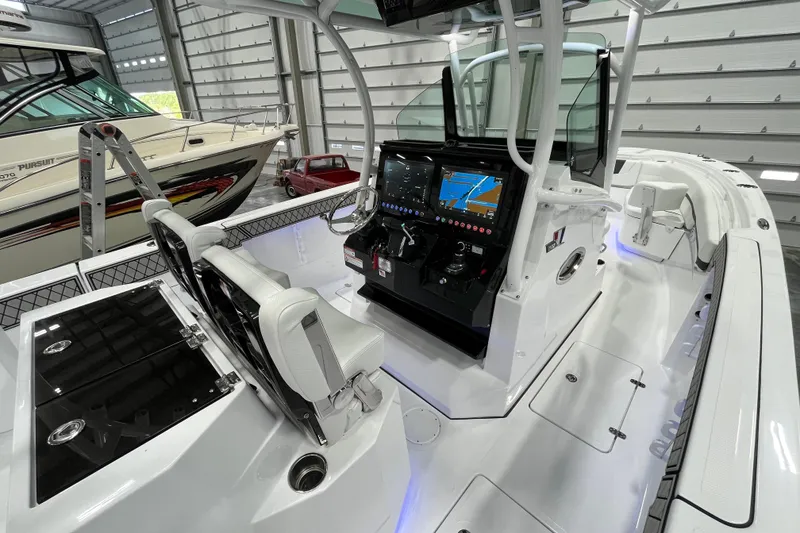 Slide: The Image of 2026 Wellcraft 302 Fisherman boat interior with modern navigation system in a showroom. - 16