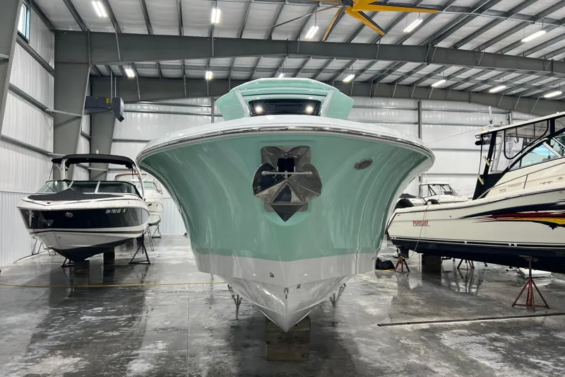 Slide: The Image of 2026 Wellcraft 302 Fisherman boat in a showroom, front view. - 2