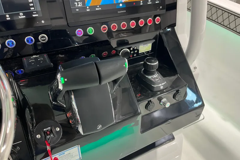 Slide: The Image of 2026 Wellcraft 302 Fisherman control panel with advanced navigation and throttle systems. - 20