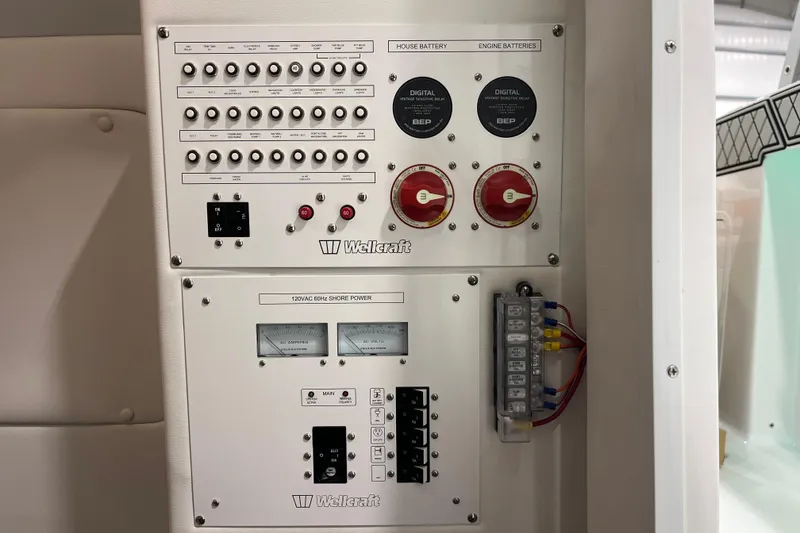 Slide: The Image of Electrical control panel of 2026 Wellcraft 302 Fisherman boat, featuring switches and meters. - 25
