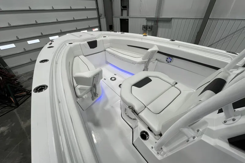 Slide: The Image of 2026 Wellcraft 302 Fisherman boat interior with white seating and blue accent lighting. - 28