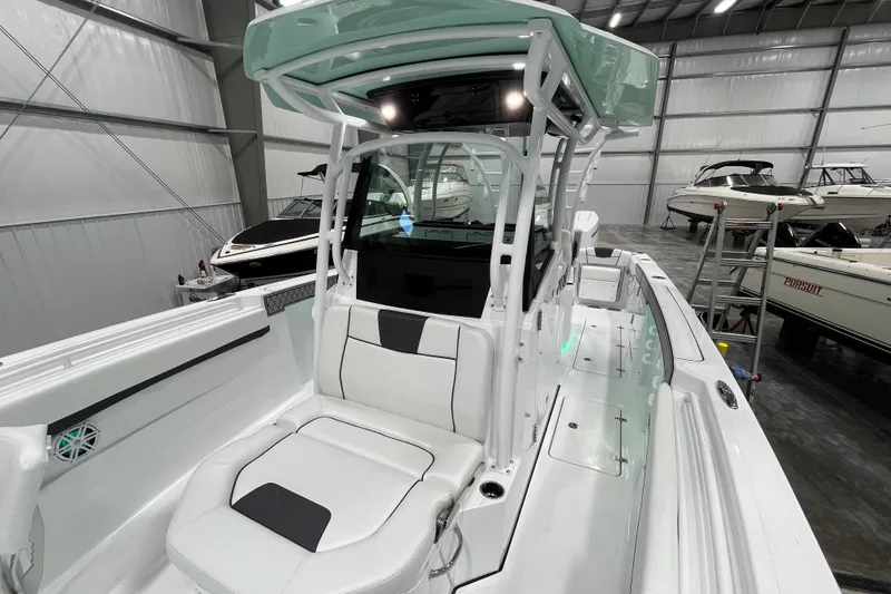 Slide: The Image of 2026 Wellcraft 302 Fisherman boat interior with sleek seating and modern design in a showroom. - 29