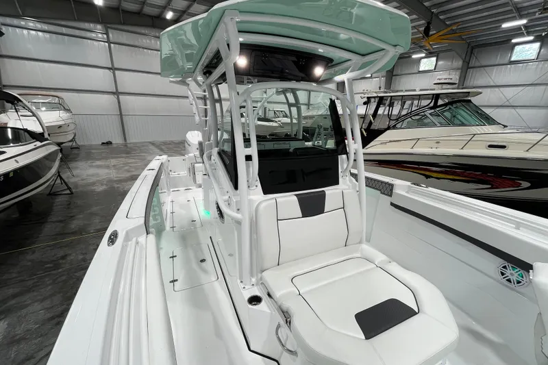 Slide: The Image of 2026 Wellcraft 302 Fisherman boat interior in a showroom, featuring sleek seating and modern design. - 30