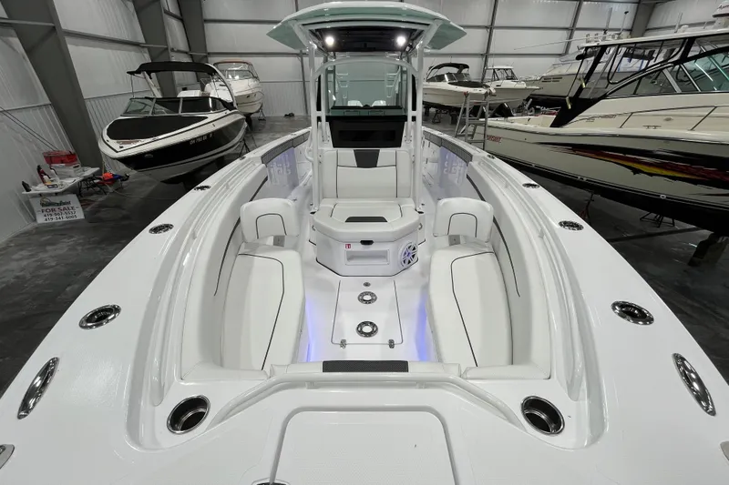 Slide: The Image of 2026 Wellcraft 302 Fisherman boat interior, sleek design, spacious seating, and modern features in showroom. - 32