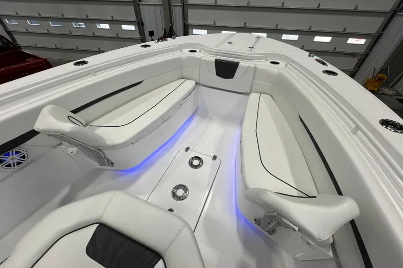 Slide: The Image of 2026 Wellcraft 302 Fisherman boat interior with white seating and blue accent lighting. - 33
