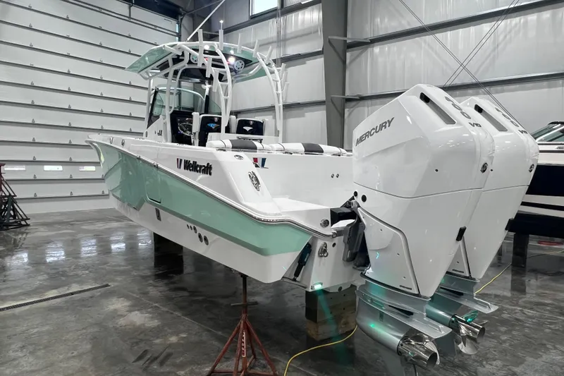 Slide: The Image of 2026 Wellcraft 302 Fisherman boat with dual Mercury engines in a showroom. - 5