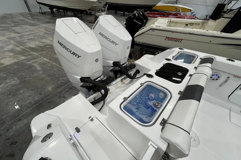 Slide: The Image of 2026 Wellcraft 302 Fisherman with dual Mercury outboard engines in a showroom. - 9