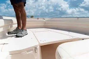 Slide: The Image of Man standing on 2026 Grady-White Fisherman 257 boat deck under cloudy sky. - 13