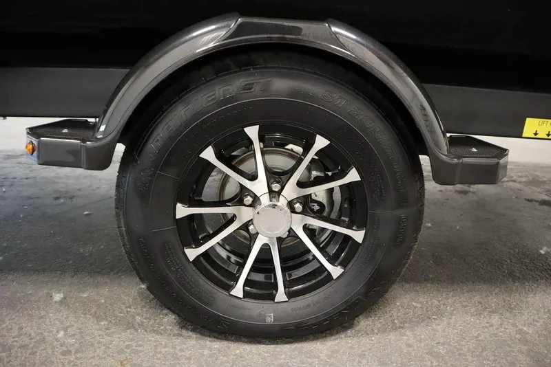 Slide: The Image of 2024 Sea-Doo Switch® 21 Sport/Cruise trailer wheel with sleek black and silver design. - 39