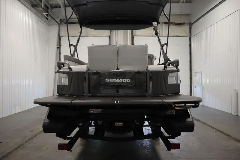 Slide: The Image of 2024 Sea-Doo Switch® 21 Sport/Cruise, rear view in a garage setting. - 7
