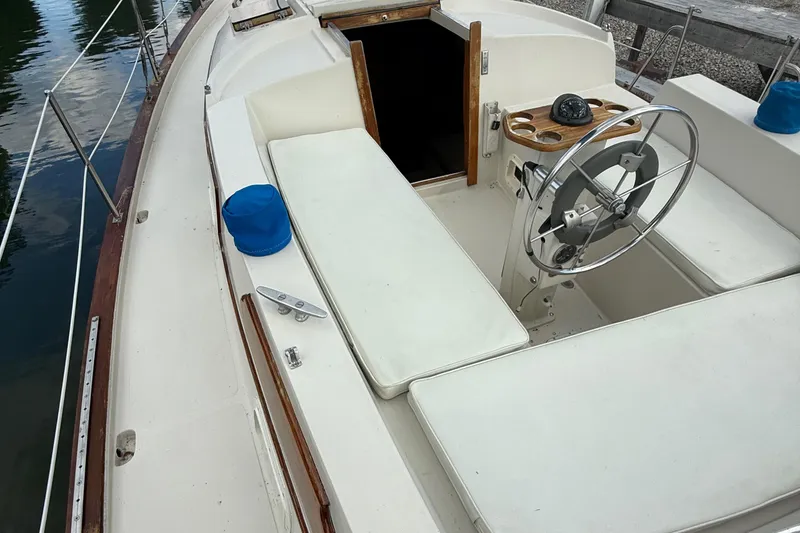 Slide: The Image of 1977 Irwin 37 Mark III sailboat cockpit with steering wheel and compass. - 10