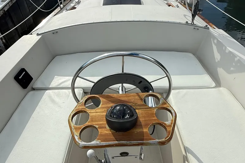 Slide: The Image of Cockpit of 1977 Irwin 37 Mark III sailboat with steering wheel and compass. - 12