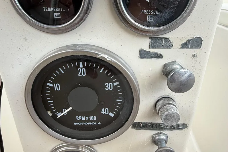 Slide: The Image of 1977 Irwin 37 Mark III boat dashboard with Motorola RPM gauge and controls. - 14