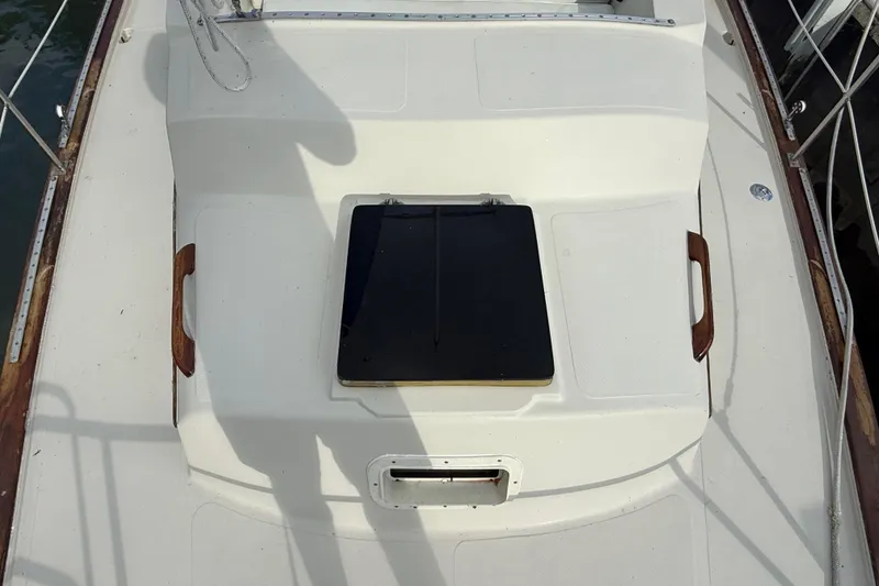 Slide: The Image of 1977 Irwin 37 Mark III sailboat deck with hatch and wooden handles. - 15