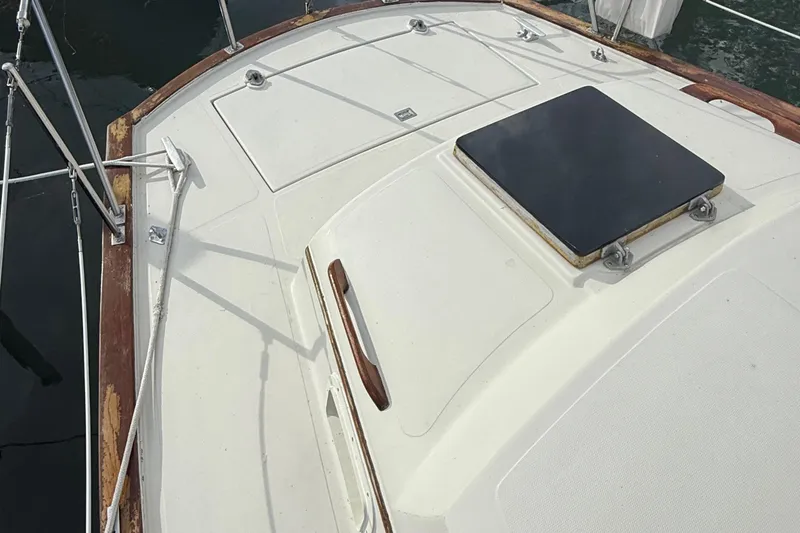 Slide: The Image of 1977 Irwin 37 Mark III sailboat deck with hatch and wooden trim. - 16