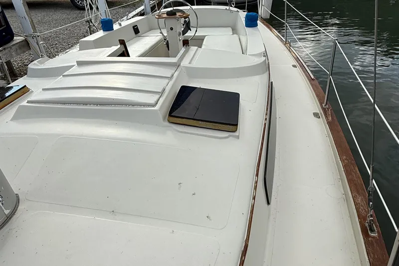 Slide: The Image of 1977 Irwin 37 Mark III sailboat deck with white finish and wooden accents. - 22