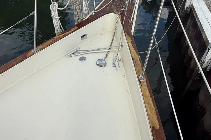 Slide: The Image of 1977 Irwin 37 Mark III sailboat deck with anchor chain and railing. - 25