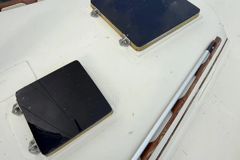 Slide: The Image of 1977 Irwin 37 Mark III yacht deck with hatches and a pole. - 26