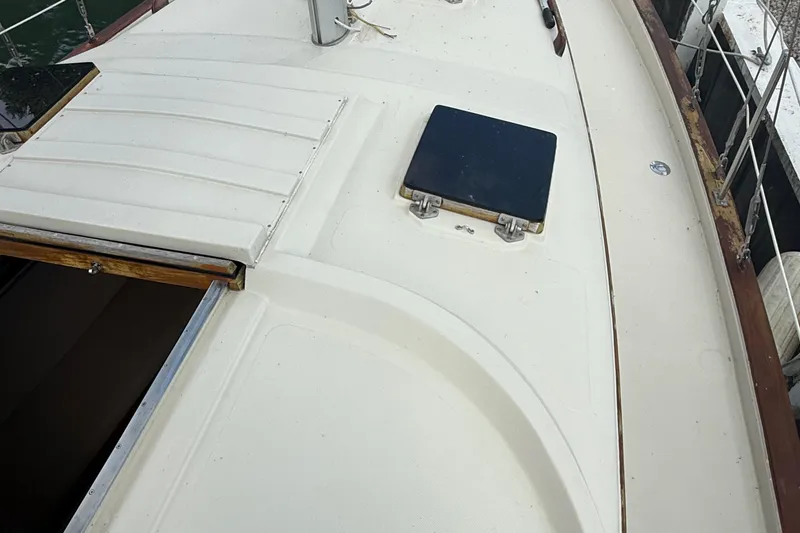 Slide: The Image of Deck view of a 1977 Irwin 37 Mark III sailboat, featuring a hatch and railing. - 28