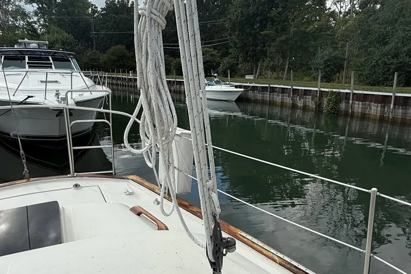 Slide: The Image of Sailboat view from 1977 Irwin 37 Mark III docked near other boats in a serene marina. - 29