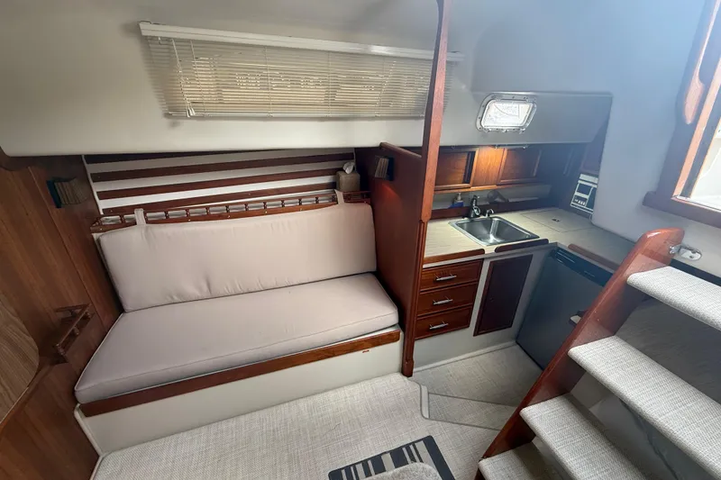 Slide: The Image of 1977 Irwin 37 Mark III yacht interior with kitchenette and seating area. - 30