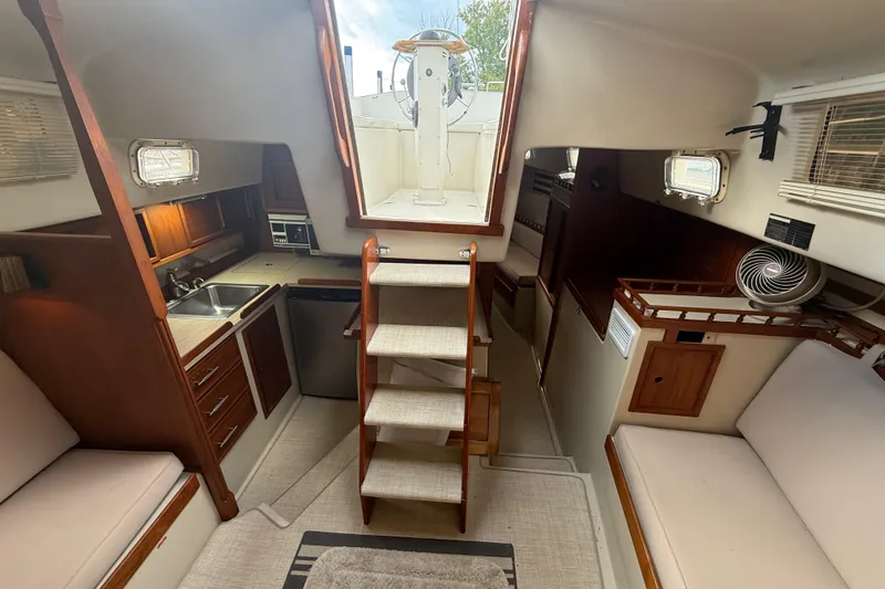Slide: The Image of Interior of 1977 Irwin 37 Mark III sailboat with cozy seating and compact kitchen. - 31