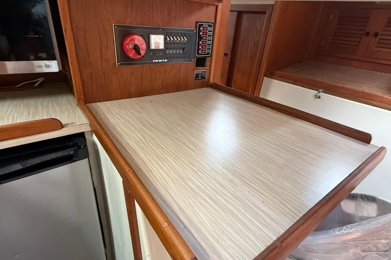 Slide: The Image of 1977 Irwin 37 Mark III interior with control panel and wooden cabinetry. - 35