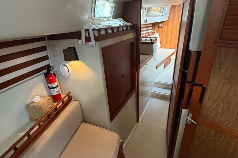 Slide: The Image of Interior of 1977 Irwin 37 Mark III sailboat, featuring cozy seating and wooden accents. - 40