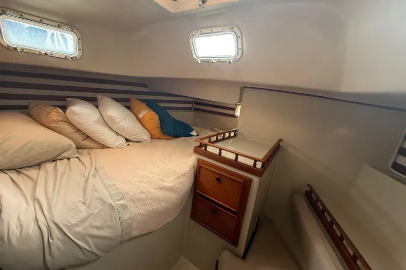 Slide: The Image of Cozy cabin interior of 1977 Irwin 37 Mark III sailboat with bed and storage. - 44