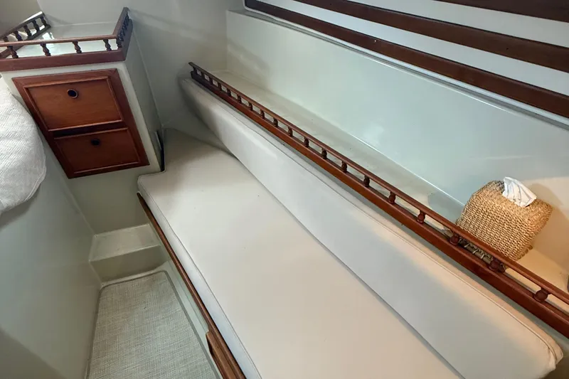 Slide: The Image of Interior of 1977 Irwin 37 Mark III sailboat with cushioned seating and wooden accents. - 45