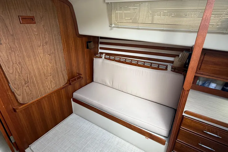 Slide: The Image of 1977 Irwin 37 Mark III interior with wooden paneling and cushioned seating. - 47