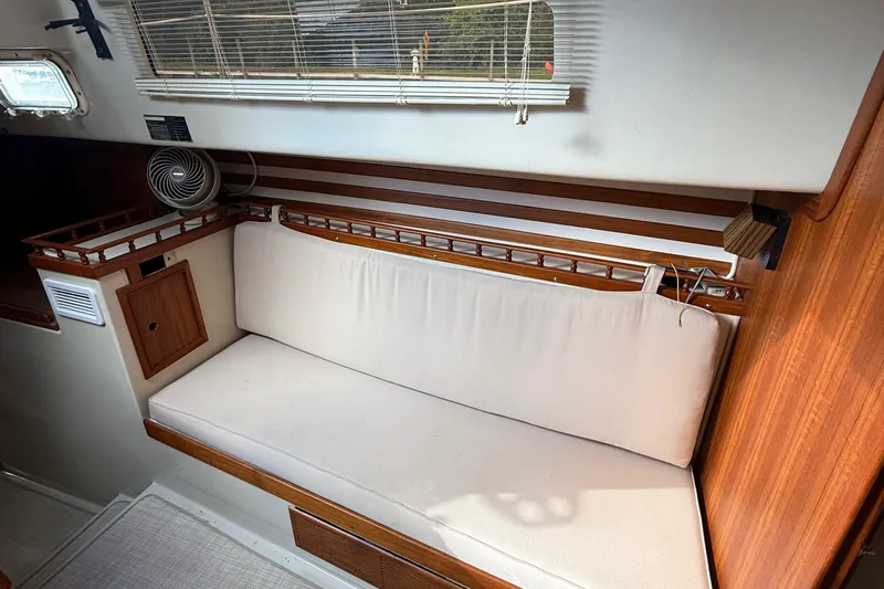 Slide: The Image of Interior of 1977 Irwin 37 Mark III sailboat with cushioned seating and wooden accents. - 48