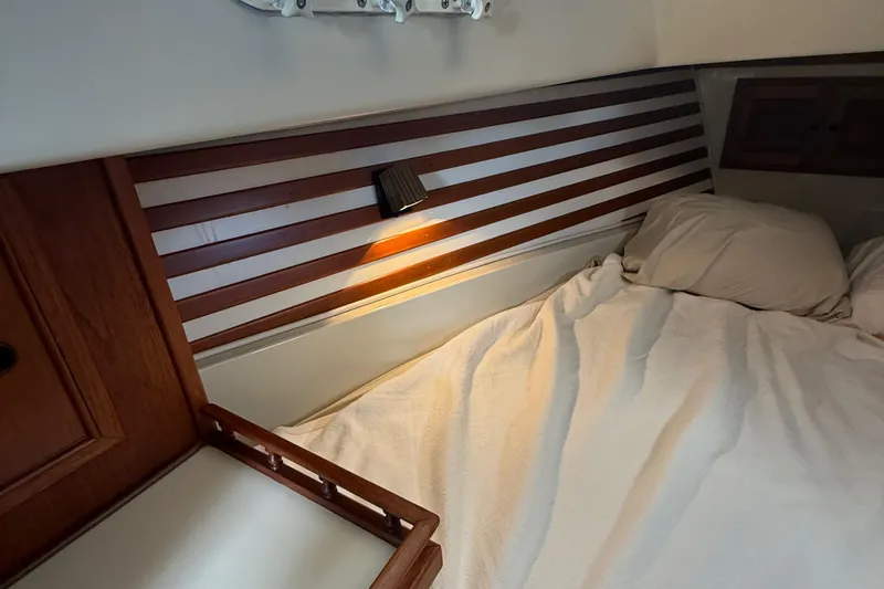 Slide: The Image of Cozy cabin interior of 1977 Irwin 37 Mark III sailboat with wooden accents and soft lighting. - 49