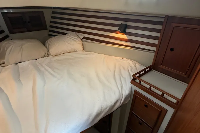Slide: The Image of Cozy cabin interior of 1977 Irwin 37 Mark III sailboat with bed and wooden cabinetry. - 50