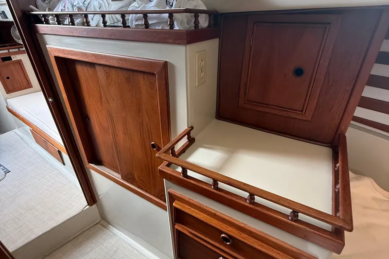 Slide: The Image of 1977 Irwin 37 Mark III interior with wooden cabinetry and storage compartments. - 53