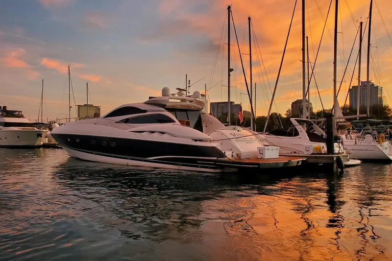 The Image of Sunseeker Predator 75 yacht docked at sunset, reflecting on calm water, 1999 model. - 1