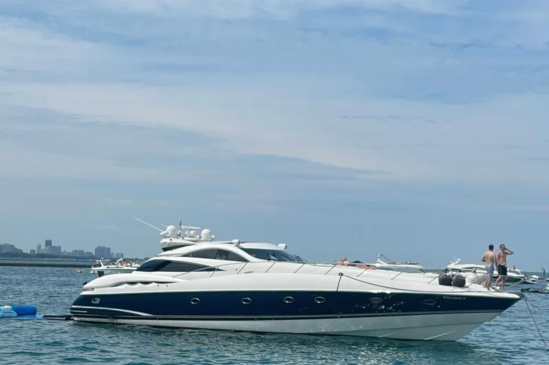Slide: The Image of Sunseeker Predator 75 yacht from 1999 on calm waters, with people enjoying the deck. - 3