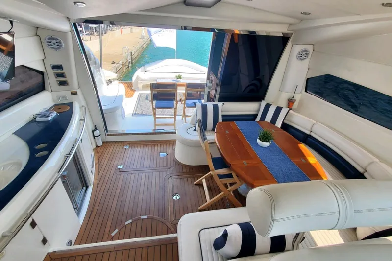 Slide: The Image of Luxurious interior of 1999 Sunseeker Predator 75 yacht with elegant seating and dining area. - 4