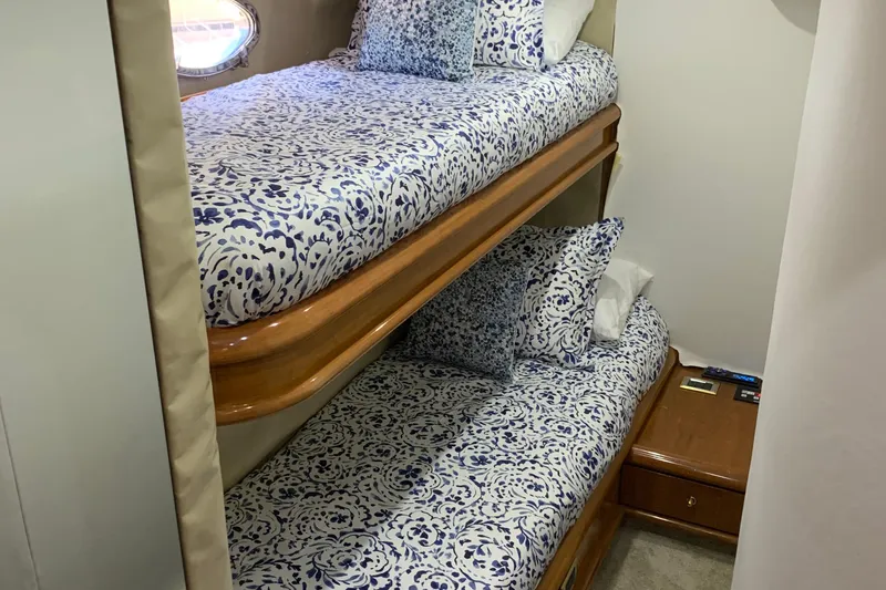 Slide: The Image of Bunk beds with patterned bedding in a 1999 Sunseeker Predator 75 yacht cabin. - 8