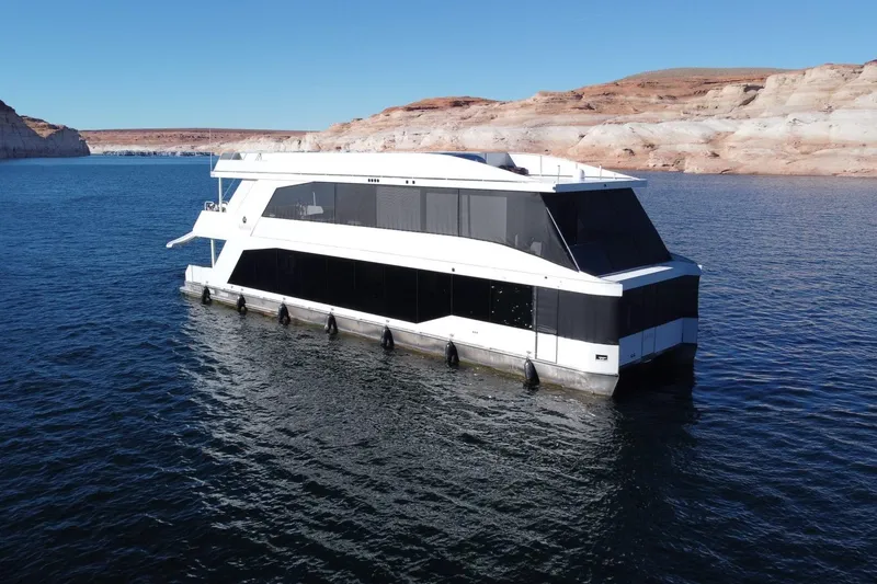 Slide: The Image of Modern Adonia Oasis Share #3 houseboat on serene lake, 2025 model. - 1