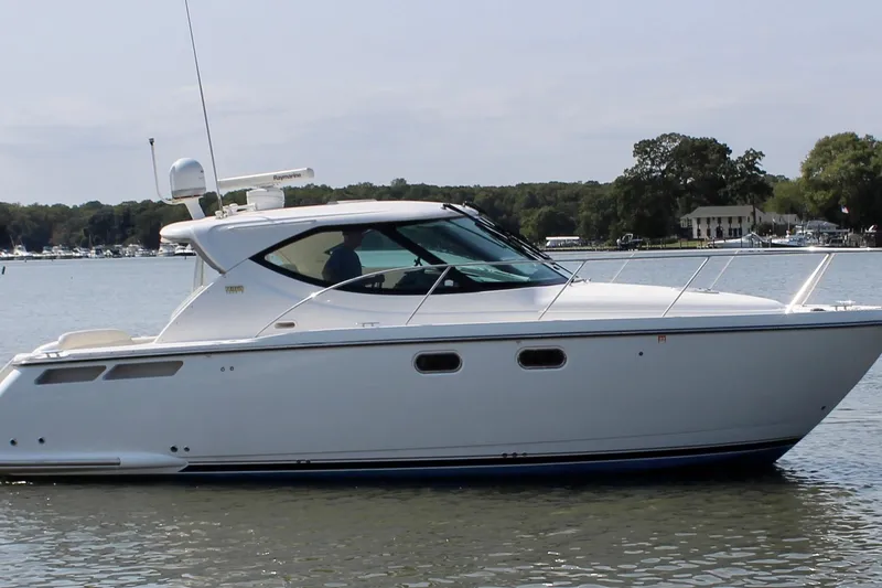 The Image of 2008 Tiara Yachts 3500 Sovran cruising on a calm lake with scenic background. - 0