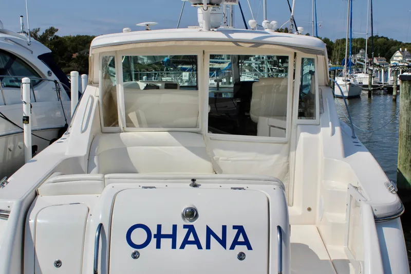 Slide: The Image of 2008 Tiara Yachts 3500 Sovran docked, rear view with "OHANA" name visible. - 11