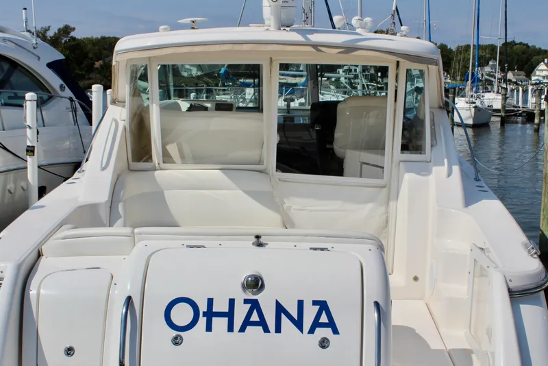 Slide: The Image of 2008 Tiara Yachts 3500 Sovran docked, rear view with "OHANA" name visible. - 12
