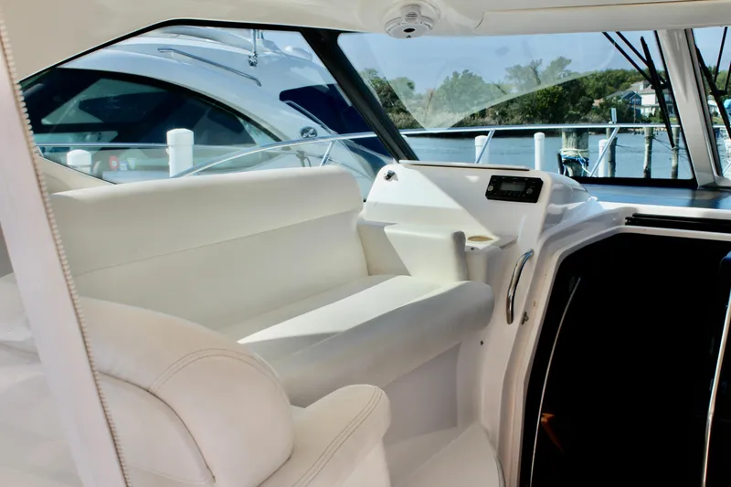 Slide: The Image of 2008 Tiara Yachts 3500 Sovran interior with white seating and control panel. - 18