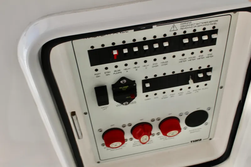 Slide: The Image of Control panel of a 2008 Tiara Yachts 3500 Sovran, featuring switches and circuit breakers. - 22
