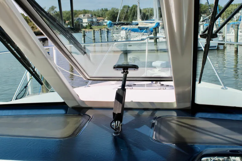 Slide: The Image of 2008 Tiara Yachts 3500 Sovran helm view with marina background. - 29