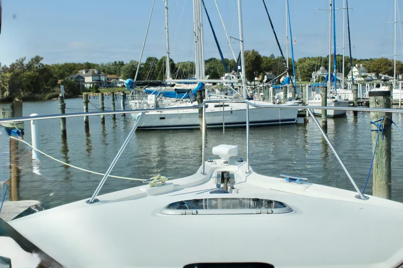 Slide: The Image of 2008 Tiara Yachts 3500 Sovran docked in a marina with sailboats. - 31
