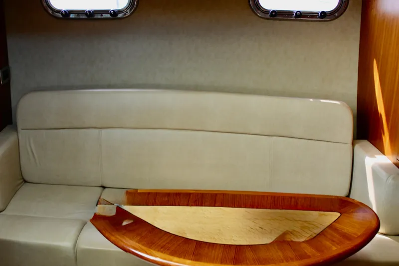Slide: The Image of Interior of 2008 Tiara Yachts 3500 Sovran with beige seating and wooden table. - 34