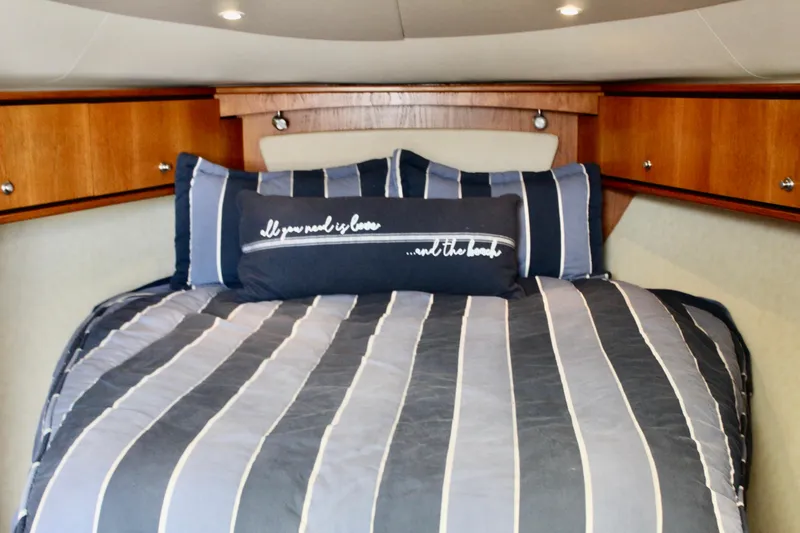 Slide: The Image of Luxurious cabin interior of 2008 Tiara Yachts 3500 Sovran with striped bedding. - 36